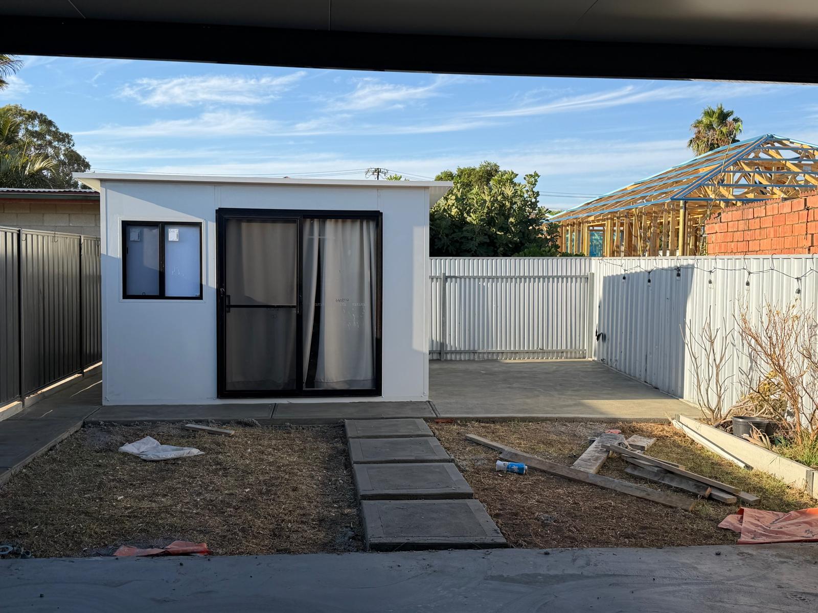 Backyard before landscaping — bare dirt and plain fencing