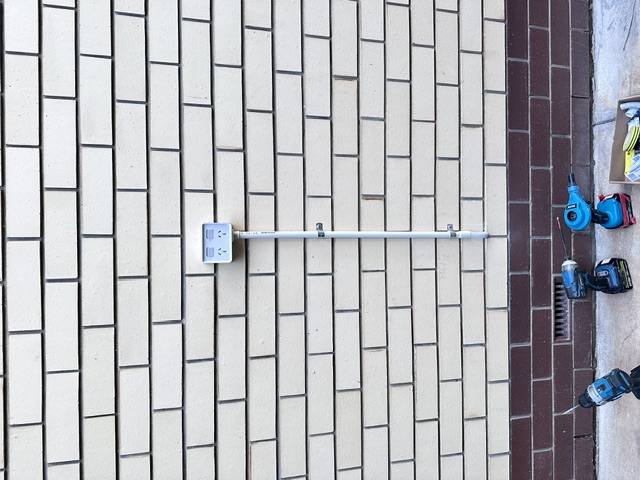 Single outdoor power point on brick wall before upgrade