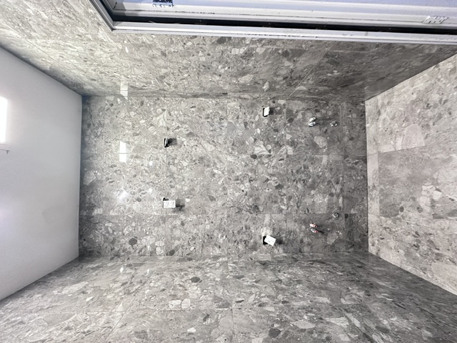 Ensuite mid-renovation, freshly tiled shower
