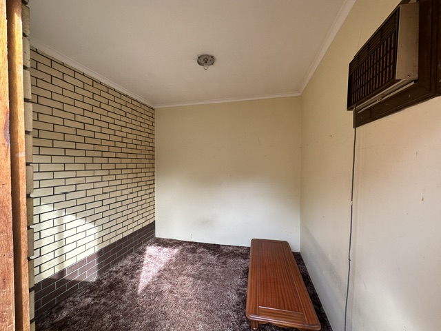 Room with worn brown carpet before new flooring