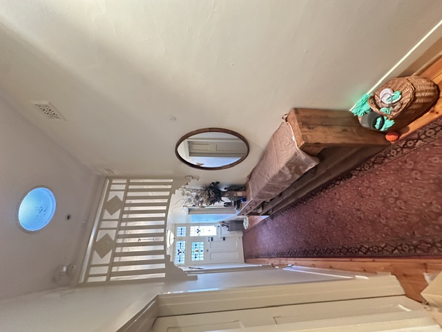 Heavy mirror hung securely on the heritage hallway wall
